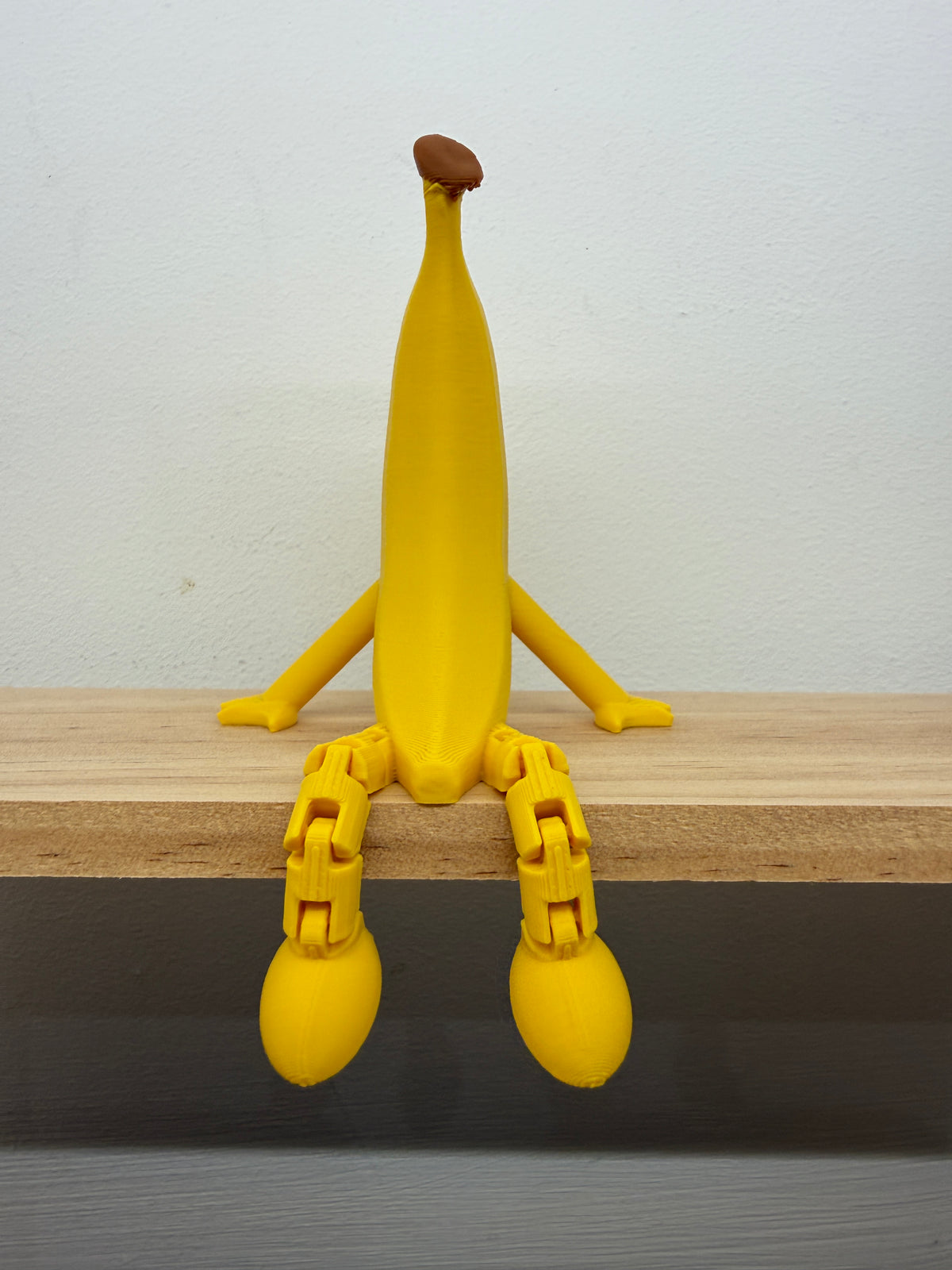 Banana Shelf Sitter with Dangling Legs